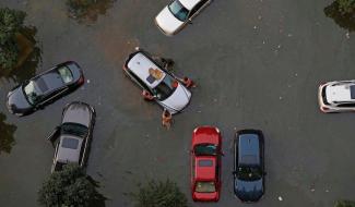 Vehicles are submerged in floodwaters on July 9, 2016 in Wuhan, Hubei Province of China. Many parts of the Wuhan area were submerged in floodwaters during July as torrential rains affected the Yangtze River valley. A new study finds that climate change increased the risk of the rains that led to the flooding by 17 – 59%. Photo: VCG/VCG via Getty Images.