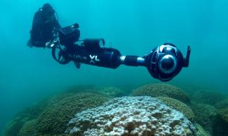 The XL Catlin Seaview Survey deployed a rapid response team to capture images of coral bleaching as it was happening in Hawaii and Florida. The photo shows Manuel Gonzalez recording the bleaching in Hawaii in 2015 using the SVII camera. Photo: XL Catlin Seaview Survey