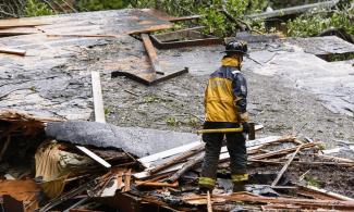 Southern Marin fire department members search a crushed house in the aftermath of a mudslide that destroyed three homes on a hillside in Sausalito, California, on Thursday. Photo: Michael Short, AP