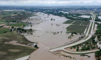 This picture was taken above Greeley, Colo. on Sept. 16, 2013. As a result of the flooding, the state lost approximately 500 miles of roadway and more than 30 bridges. Here, U.S. 34 in Greeley is breached by the South Platte River in flood stage. Photo: US Environmental Protection Agency