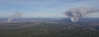 These two fires started at about the same time on May 1, 2016 near Fort McMurray, Alberta, Canada. Seen just after they started, on the left is the MMD-004 fire inside the city limits of Fort McMurray. The Horse River Fire, often referred to as the Fort McMurray Fire, is on the right. Alberta Forestry photo.