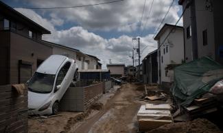 A street devastated by floods and landslides in Mabi, Okayama prefecture. Credit: Martin Bureau, AFP