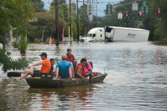 A small boat transports flood victims down Old Hammond Highway in east Baton Rouge on Aug. 14, 2016. Photo: Travis Spradling, The Advocate
