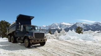 This March 2, 2017 photo provided by the California National Guard shows a Guard dump truck helping to clear huge snow drifts from the Eastern Sierra town of Mammoth Lakes, Calif. Photo: California National Guard via AP