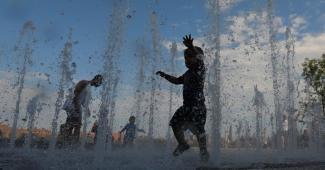 Children beat the heat in New York on Sunday in Brooklyn’s Domino Park waterworks. Credit: Andrew Kelly, Reuters