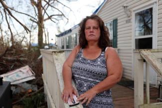 Melissa Hutchinson, 51, poses for a portrait near debris from Hurricane Michael outside her home in Panama City, Florida, U.S., November 5, 2018. Photo: Terray Sylvester, Reuters